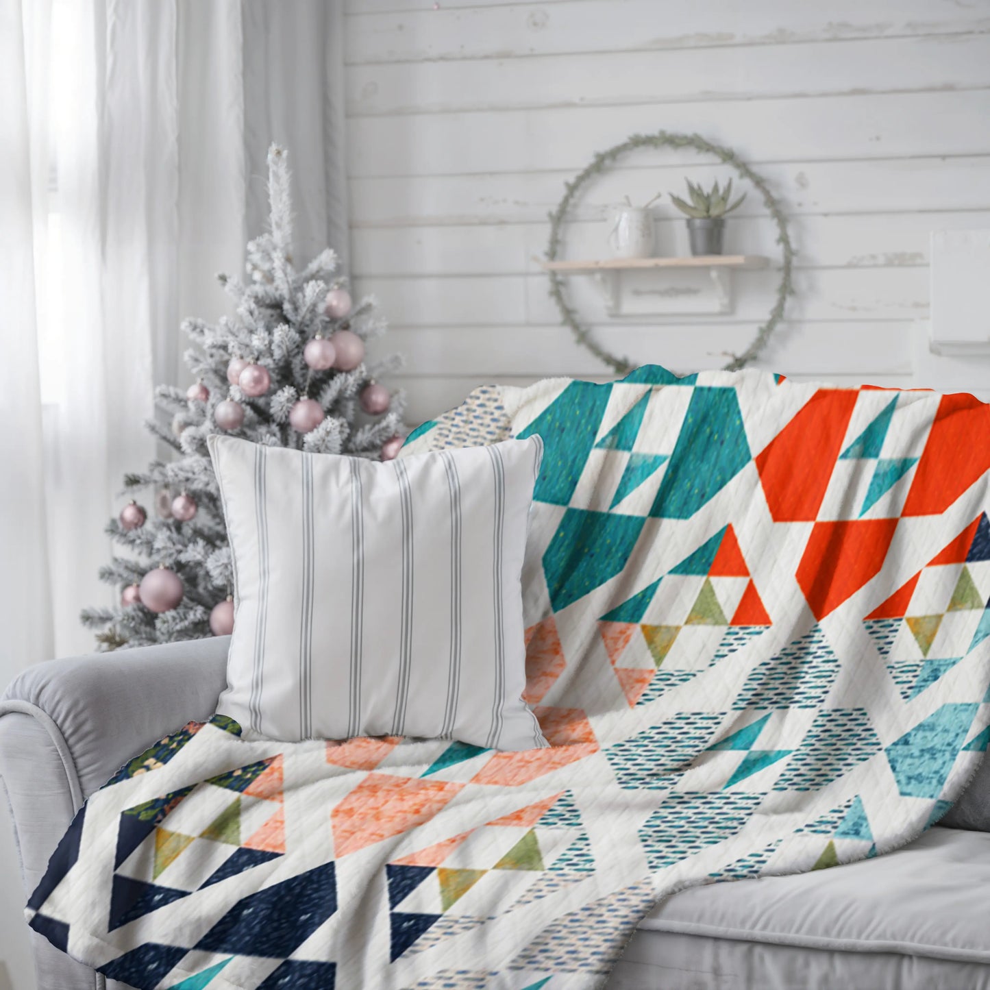 A handmade patchwork quilt with intricate geometric shapes in various colors, adding warmth and style to any bedroom.