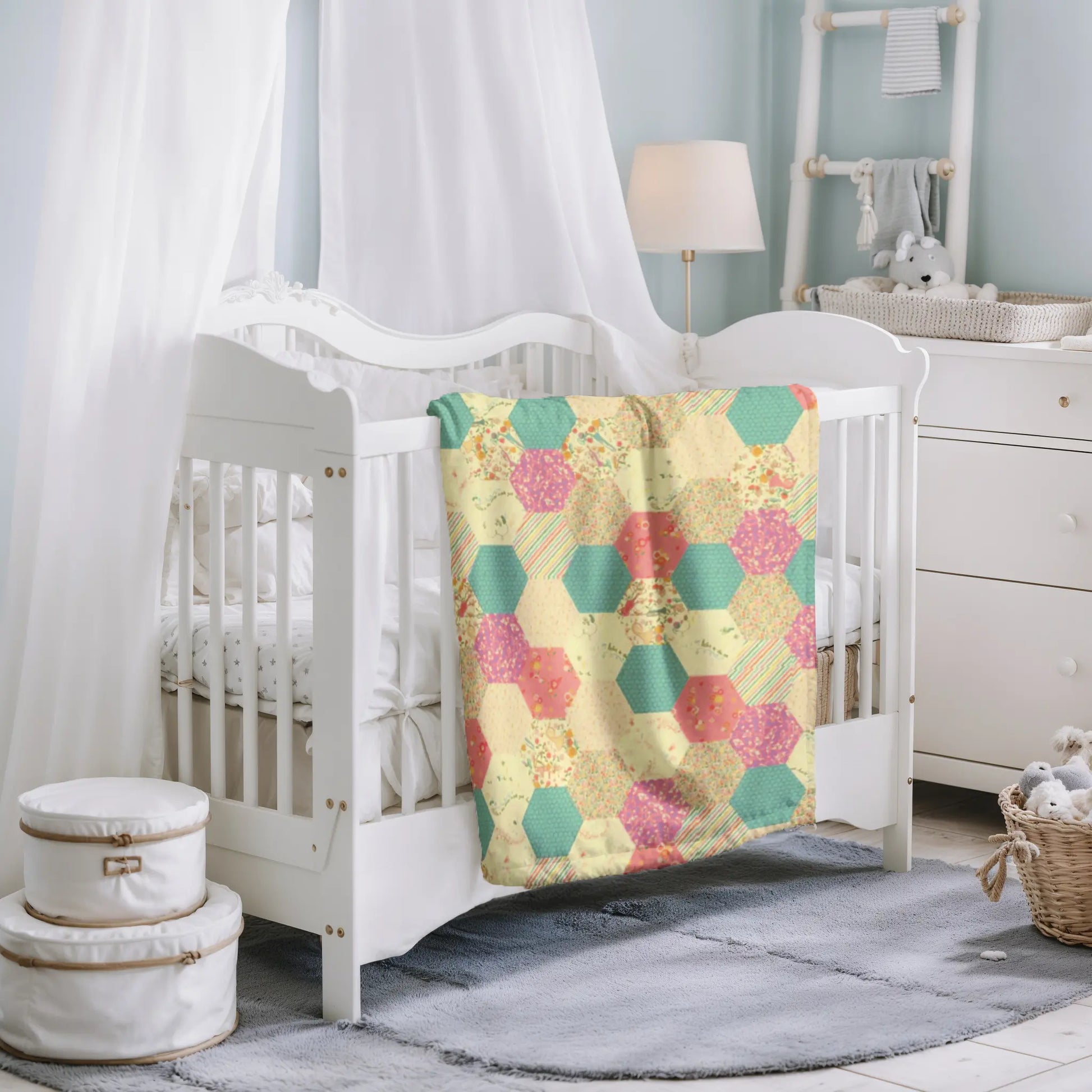 Soft and warm quilt with a vintage hexagon pattern in floral and striped fabric, adding a charming touch to any nursery or home.