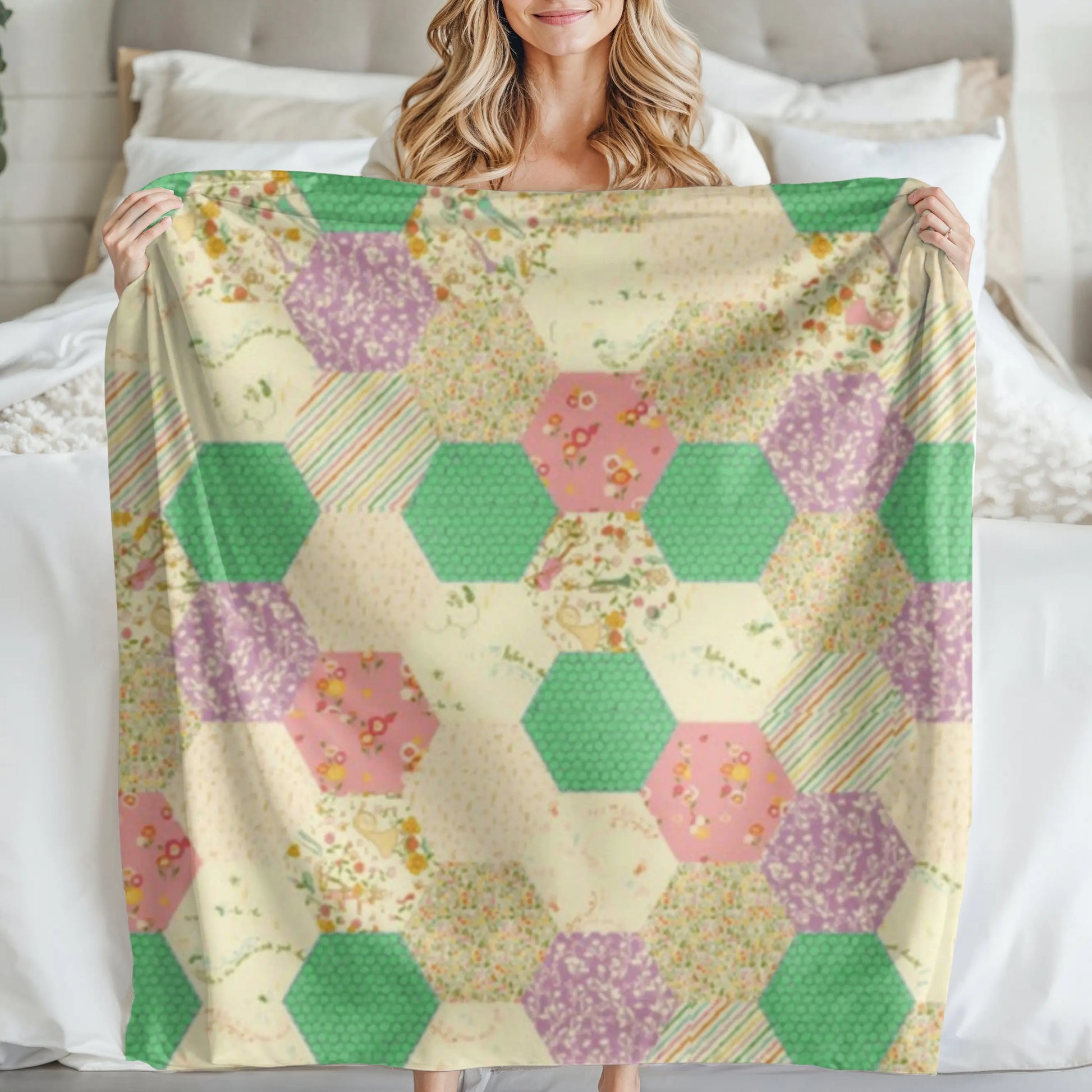 A cozy quilt featuring a hexagonal patchwork design with pastel shades of yellow, pink, green, and purple, draped over a wooden floor