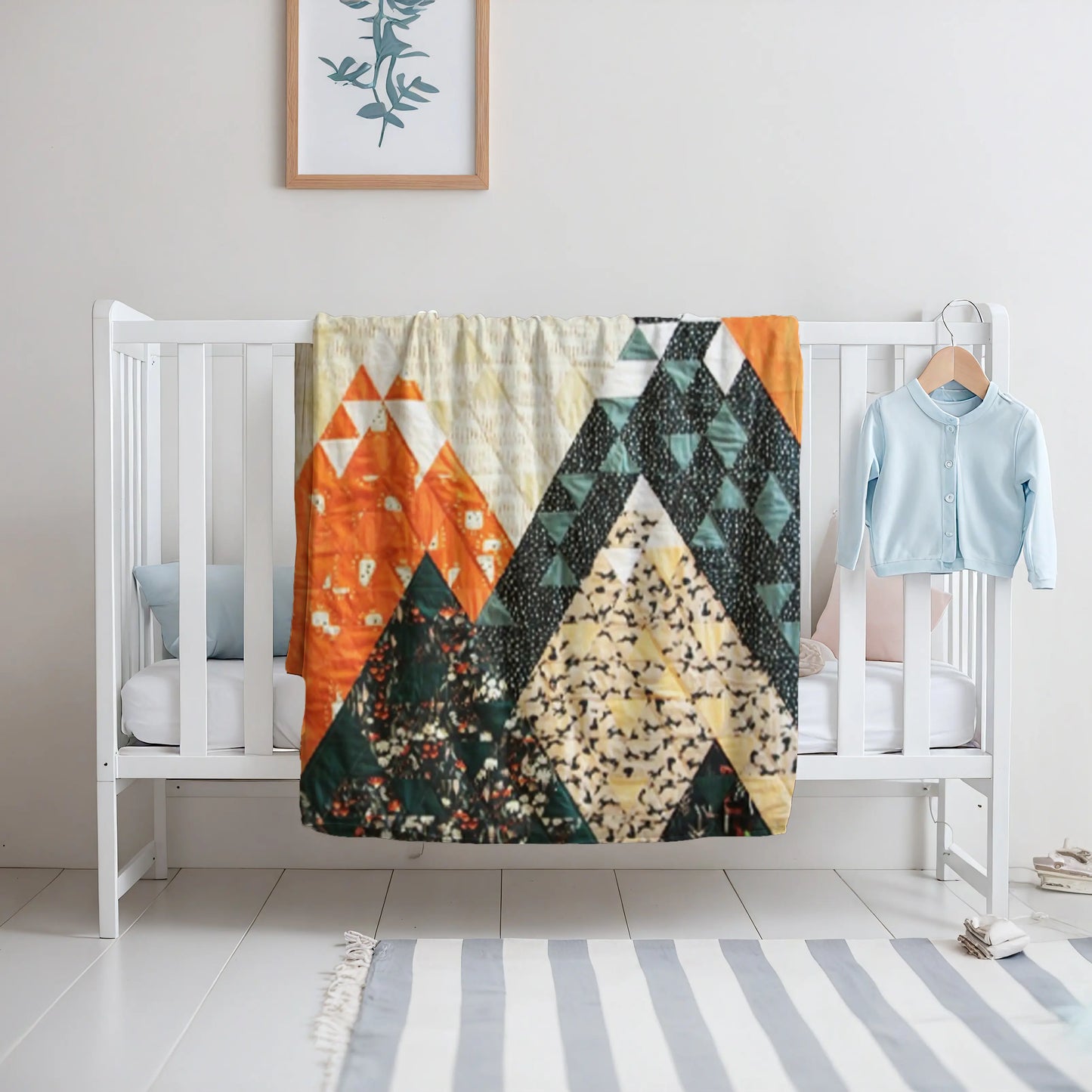 A soft and artistic quilt featuring geometric mountain shapes, creating a unique and stylish home decor piece.